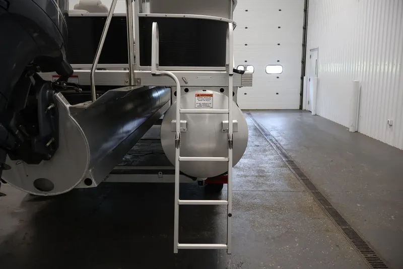 Slide: The Image of 2023 Bennington SV 22 Quad Bench pontoon boat with ladder in a garage. - 41