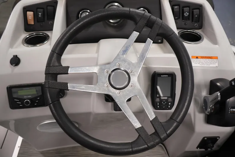 Slide: The Image of Steering console of 2023 Bennington SV 22 Quad Bench with controls and Garmin device. - 19
