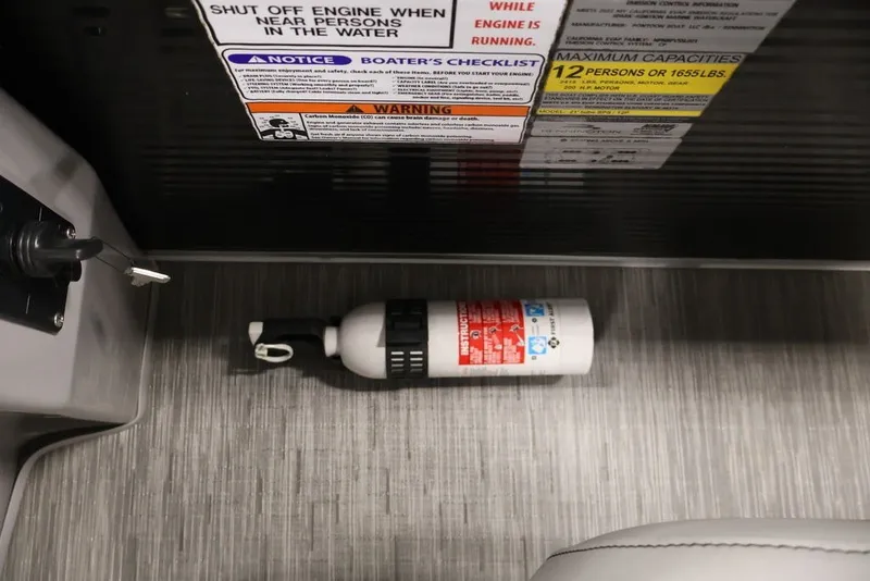 Slide: The Image of Fire extinguisher on Bennington SV 22 Quad Bench boat floor, safety instructions visible. - 30