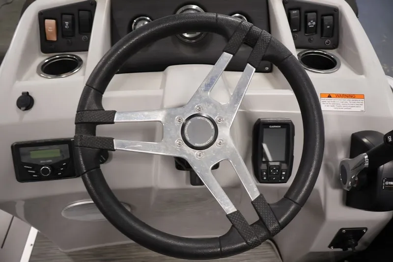 Slide: The Image of Steering console of 2023 Bennington SV 22 Quad Bench with controls and Garmin device. - 19