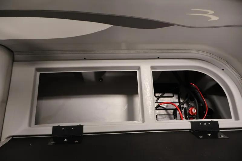 Slide: The Image of 2023 Bennington SV 22 Quad Bench storage compartment with wiring and battery setup. - 32