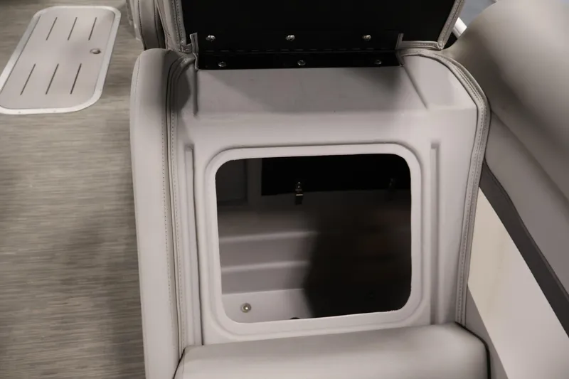 Slide: The Image of 2023 Bennington SV 22 Quad Bench storage compartment with open lid, showcasing interior space. - 31