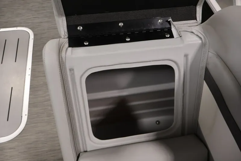 Slide: The Image of 2023 Bennington SV 22 Quad Bench storage compartment with open lid, showcasing interior space. - 15