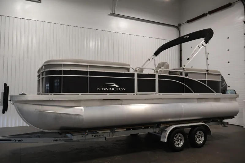 Slide: The Image of 2023 Bennington SV 22 Quad Bench pontoon boat on trailer in indoor setting. - 8