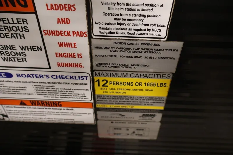 Slide: The Image of Warning and capacity labels on a 2023 Bennington SV 22 Quad Bench boat. - 20