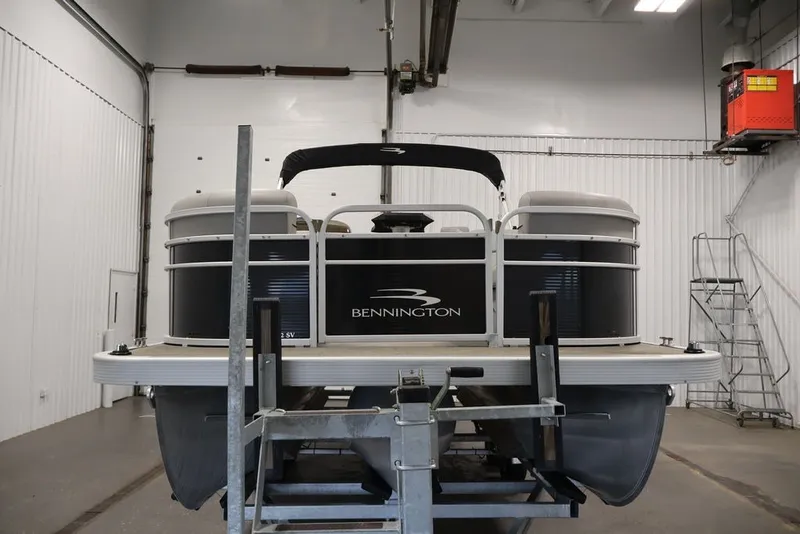 Slide: The Image of 2023 Bennington SV 22 Quad Bench pontoon boat in a storage facility. - 3
