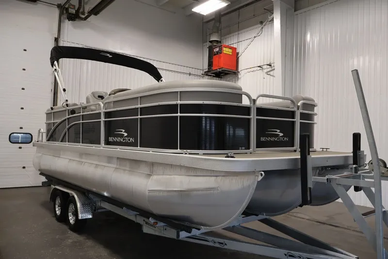 Slide: The Image of 2023 Bennington SV 22 Quad Bench pontoon boat on trailer in indoor storage. - 4