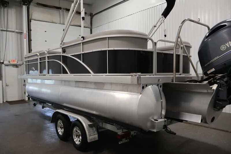 Slide: The Image of 2023 Bennington SV 22 Quad Bench pontoon boat in a garage setting. - 7
