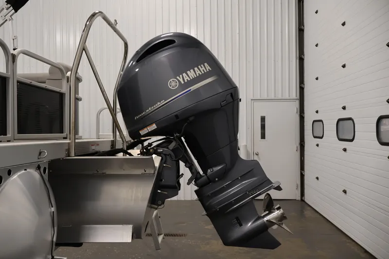 Slide: The Image of 2023 Bennington SV 22 Quad Bench with Yamaha outboard motor in a garage setting. - 36
