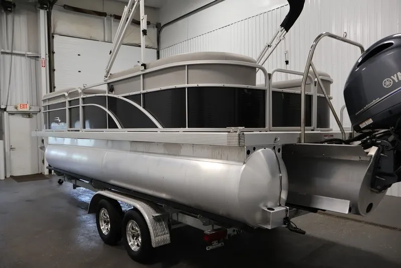 Slide: The Image of 2023 Bennington SV 22 Quad Bench pontoon boat in a garage setting. - 6