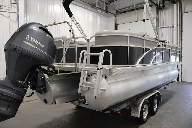 Slide: The Image of 2023 Bennington SV 22 Quad Bench pontoon boat with Yamaha motor in a garage. - 8