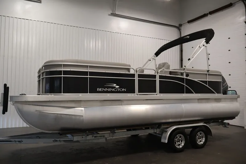Slide: The Image of 2023 Bennington SV 22 Quad Bench pontoon boat on trailer in indoor setting. - 9