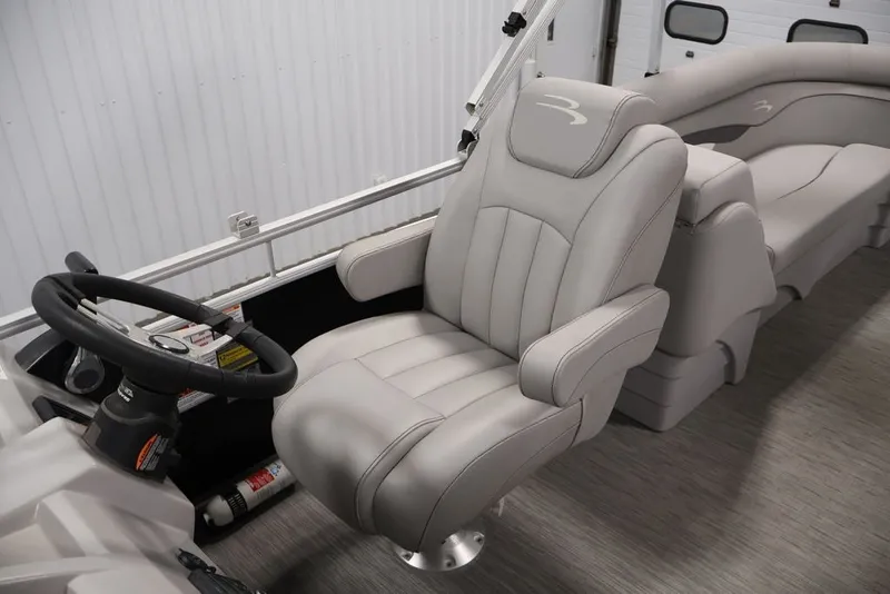 Slide: The Image of 2023 Bennington SV 22 Quad Bench interior with plush seating and steering wheel. - 21