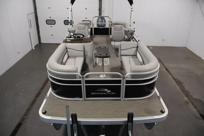 Slide: The Image of 2023 Bennington SV 22 Quad Bench pontoon boat in a showroom setting. - 9