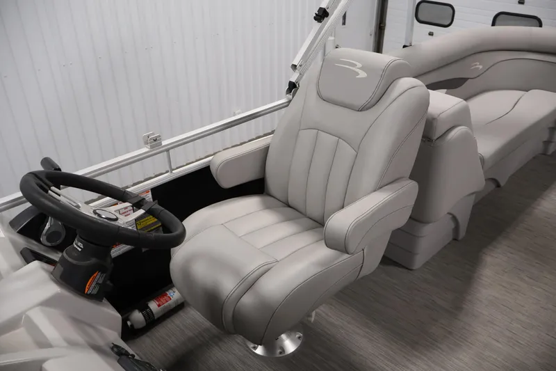 Slide: The Image of 2023 Bennington SV 22 Quad Bench interior with plush seating and steering wheel. - 27