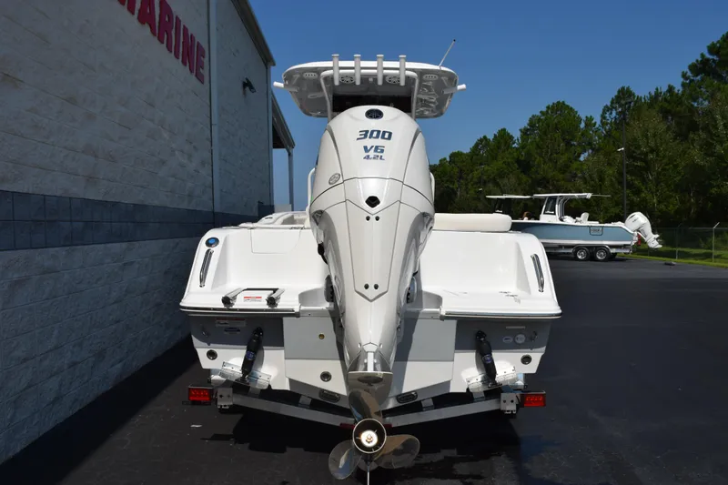 Slide: The Image of 2026 Sea Hunt Ultra 245 SE boat with powerful V6 engine, parked outdoors. - 5