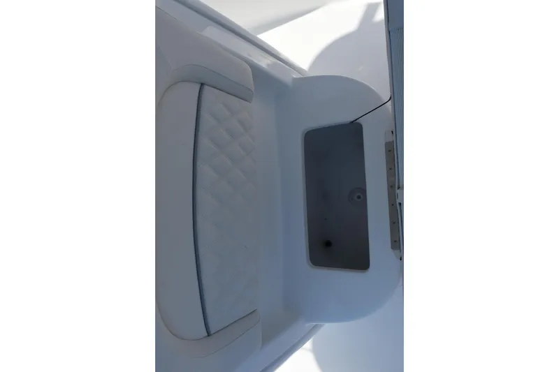 Slide: The Image of Interior view of 2026 Sea Hunt Ultra 245 SE boat, featuring seating and storage. - 16