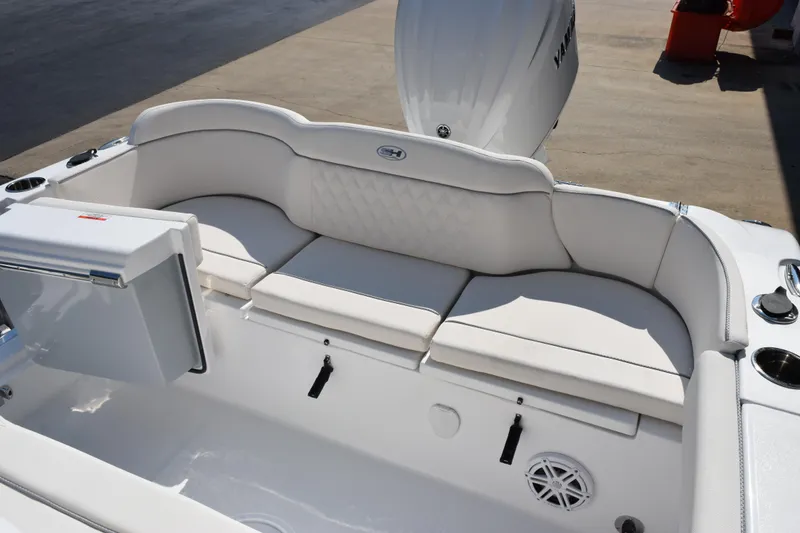 Slide: The Image of 2026 Sea Hunt Ultra 245 SE boat interior with white cushioned seating and storage compartments. - 13