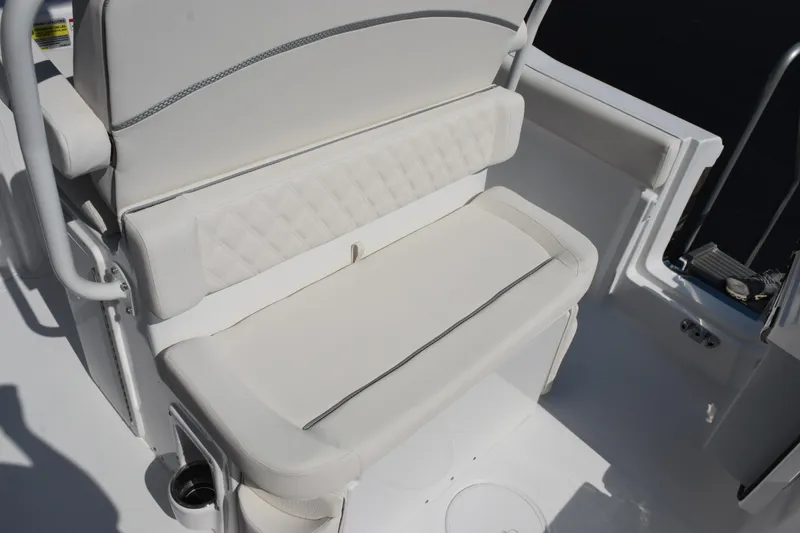 Slide: The Image of 2026 Sea Hunt Ultra 245 SE boat seat with white upholstery and cup holder. - 14
