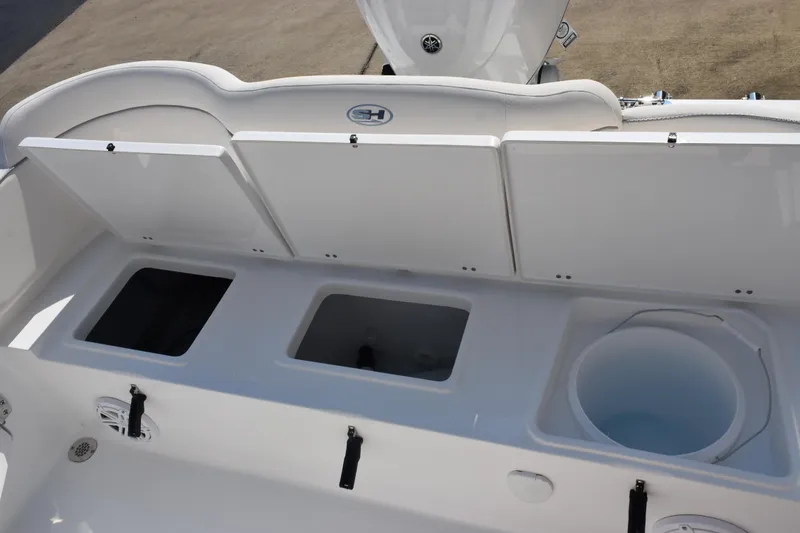 Slide: The Image of 2026 Sea Hunt Ultra 245 SE boat storage compartments and seating area. - 22