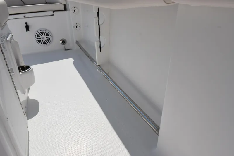 Slide: The Image of Interior view of 2026 Sea Hunt Ultra 245 SE boat, featuring sleek white design and stainless steel accents. - 18