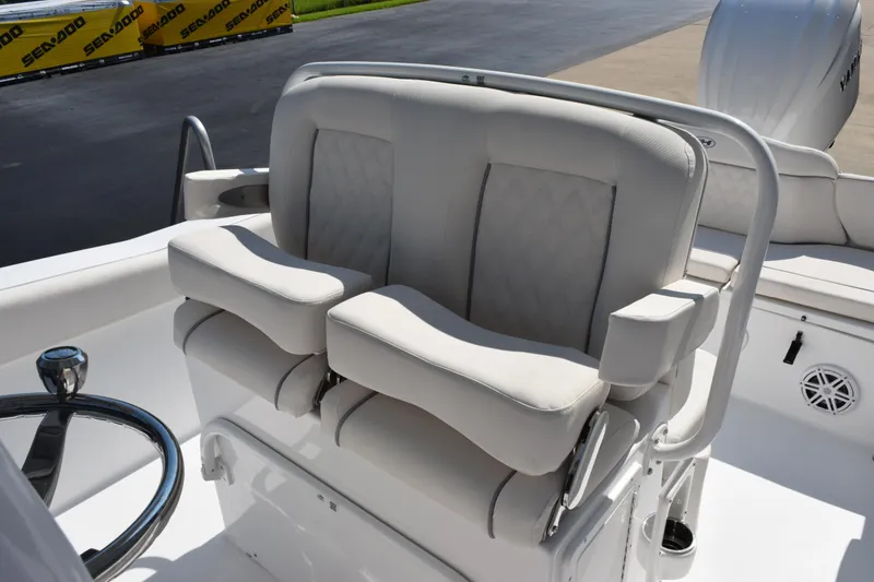 Slide: The Image of 2026 Sea Hunt Ultra 245 SE boat helm seat with cushioned armrests and steering wheel. - 10