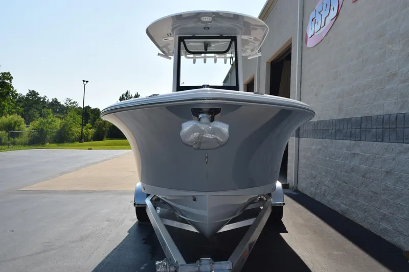 Slide: The Image of 2026 Sea Hunt Ultra 245 SE boat on trailer, parked outside a building. - 3