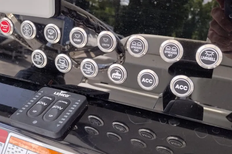 Slide: The Image of Control panel of 2024 Wellcraft 223 Fisherman boat with labeled buttons and switches. - 13