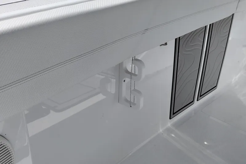 Slide: The Image of 2024 Wellcraft 223 Fisherman boat interior detail with textured surfaces and storage compartments. - 26