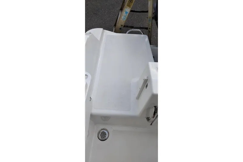 Slide: The Image of 2024 Wellcraft 223 Fisherman boat deck with drain and ladder. - 35