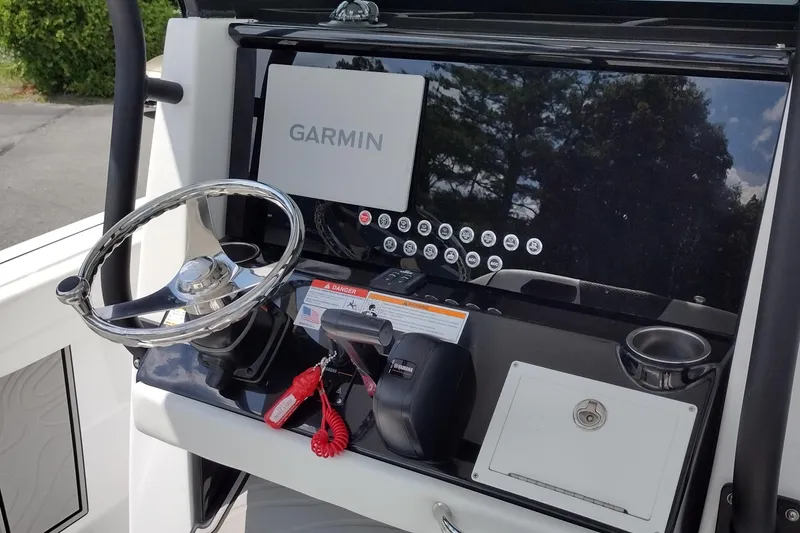 Slide: The Image of 2024 Wellcraft 223 Fisherman dashboard with Garmin display and steering wheel. - 11