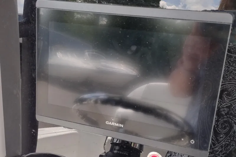 Slide: The Image of Garmin display on 2024 Wellcraft 223 Fisherman boat, reflecting surroundings. - 12