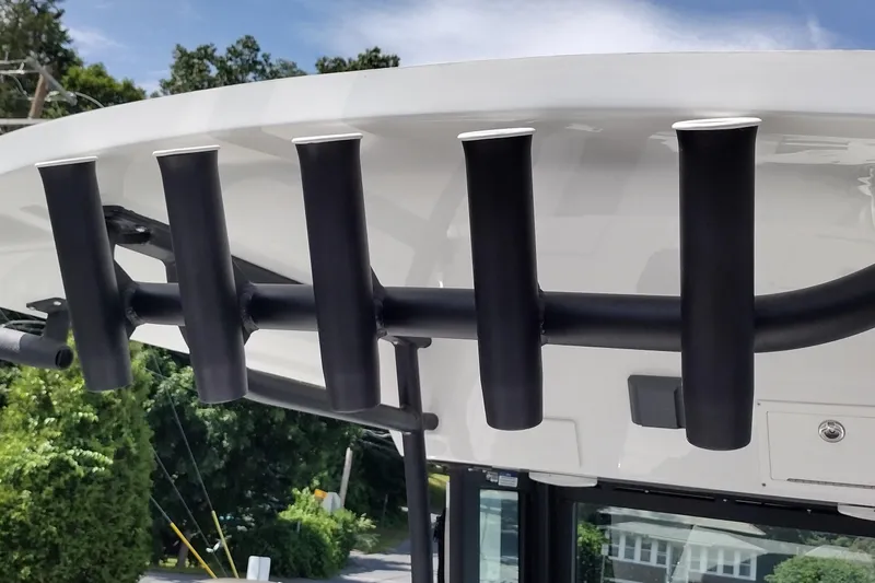 Slide: The Image of Rod holders on a 2024 Wellcraft 223 Fisherman boat, under a clear sky. - 28