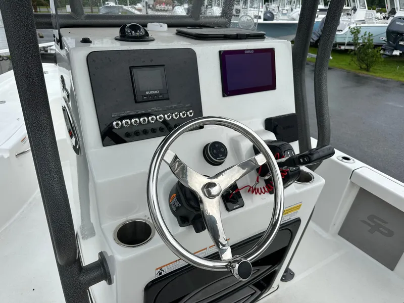 Slide: The Image of The image shows the helm of a Sea Pro 230 DLX boat with modern instruments. - 16