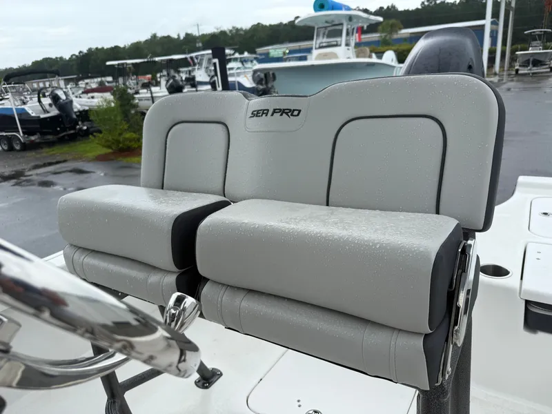 Slide: The Image of The image shows a gray bench seat on a Sea Pro 230 DLX boat. - 9