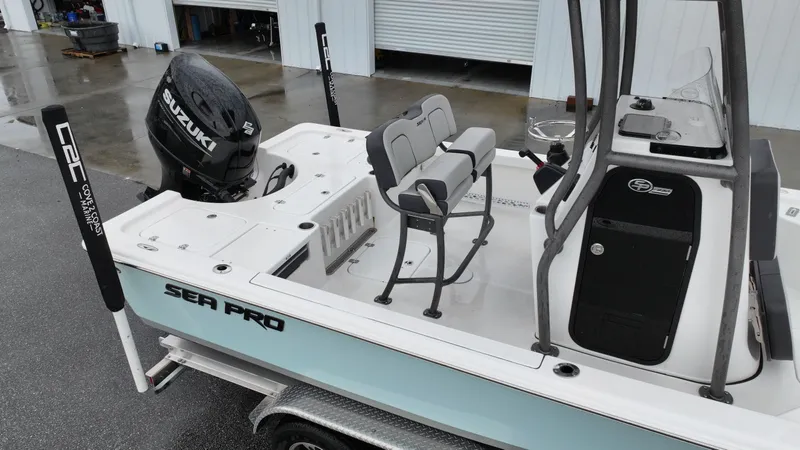 Slide: The Image of Sea Pro 230 DLX 2025 on a trailer, featuring a Suzuki engine. - 2
