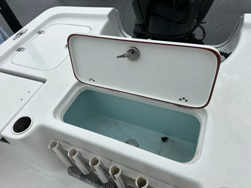Slide: The Image of The image shows the stern of a Sea Pro 230 DLX boat with an open storage compartment. - 19
