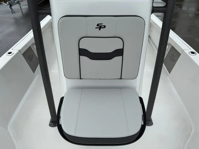 Slide: The Image of Rear view of a Sea Pro 230 DLX boat seat with gray upholstery and black logo. - 12