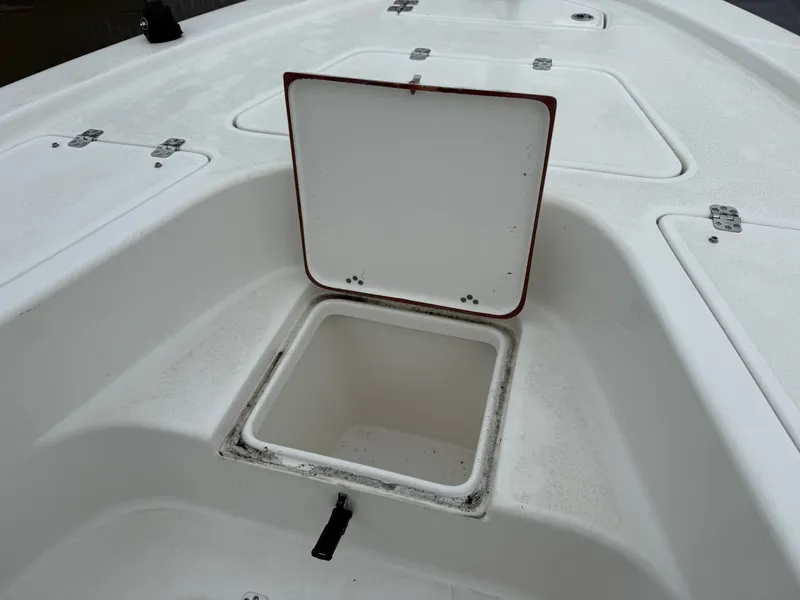 Slide: The Image of An open storage compartment on a white boat. - 14