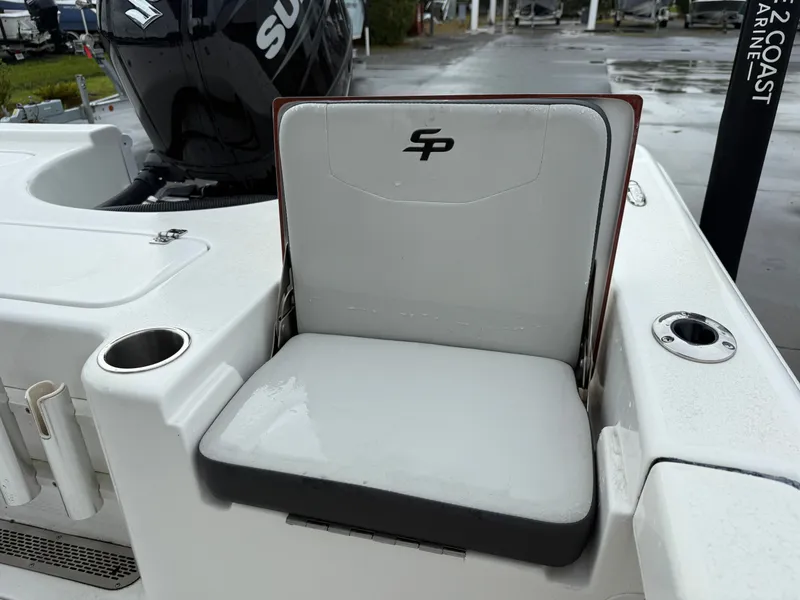 Slide: The Image of A seat on a Sea Pro 230 DLX boat with a Suzuki engine in the background. - 10