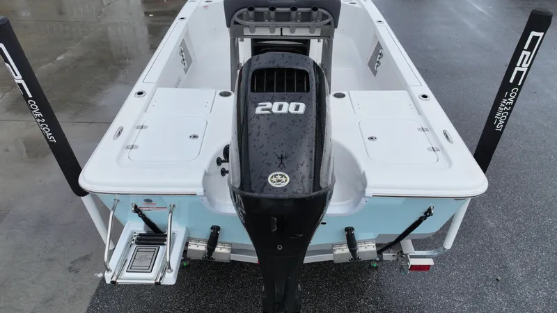 Slide: The Image of Rear view of a Sea Pro 230 DLX with a 200 HP outboard motor, on a wet dock. - 4