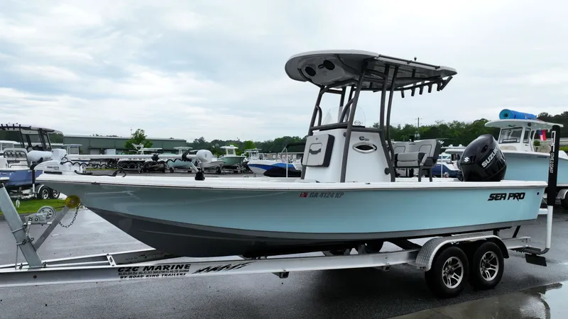 Slide: The Image of A 2025 Sea Pro 230 DLX boat on a trailer, ready for the water. - 6