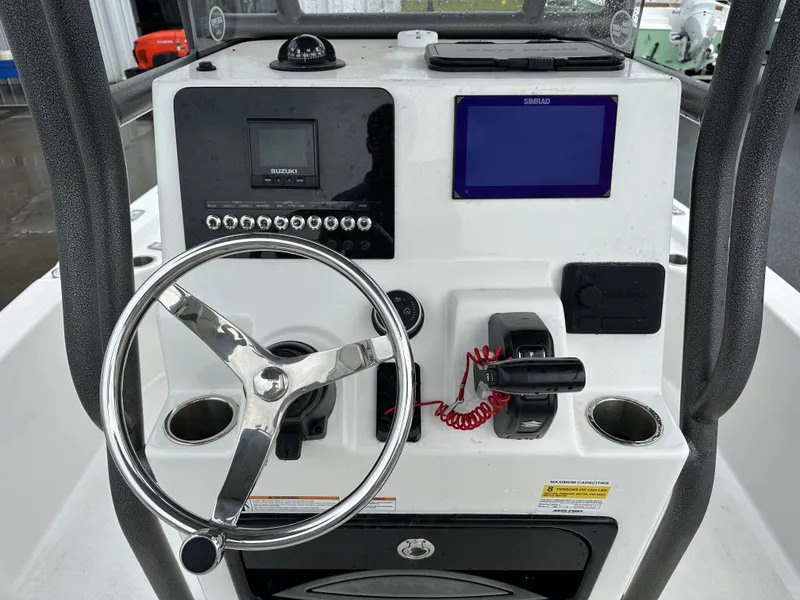 Slide: The Image of The image shows the helm of a Sea Pro 230 DLX boat with modern instruments. - 15