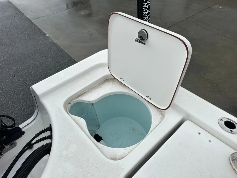 Slide: The Image of An open storage compartment on a 2025 Sea Pro 230 DLX boat. - 18