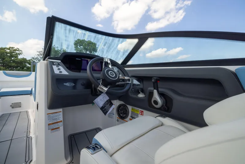 Slide: The Image of Interior view of 2026 Chaparral 250 OSX boat cockpit with steering wheel and controls. - 10