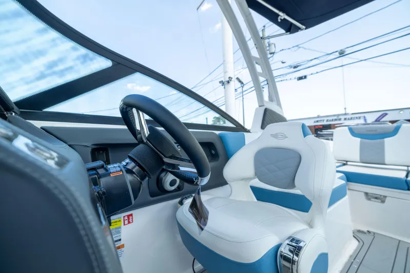 Slide: The Image of Interior view of 2026 Chaparral 250 OSX boat, featuring modern steering and seating. - 9