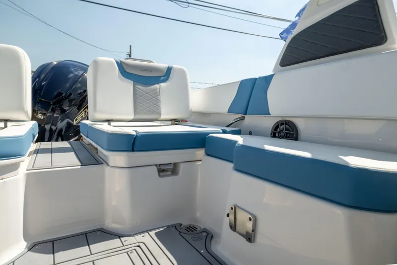 Slide: The Image of 2026 Chaparral 250 OSX boat interior with blue and white seating, showcasing modern design. - 16