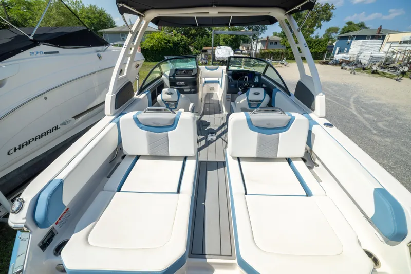 Slide: The Image of 2026 Chaparral 250 OSX boat interior with white and blue seating, showcasing modern design. - 20