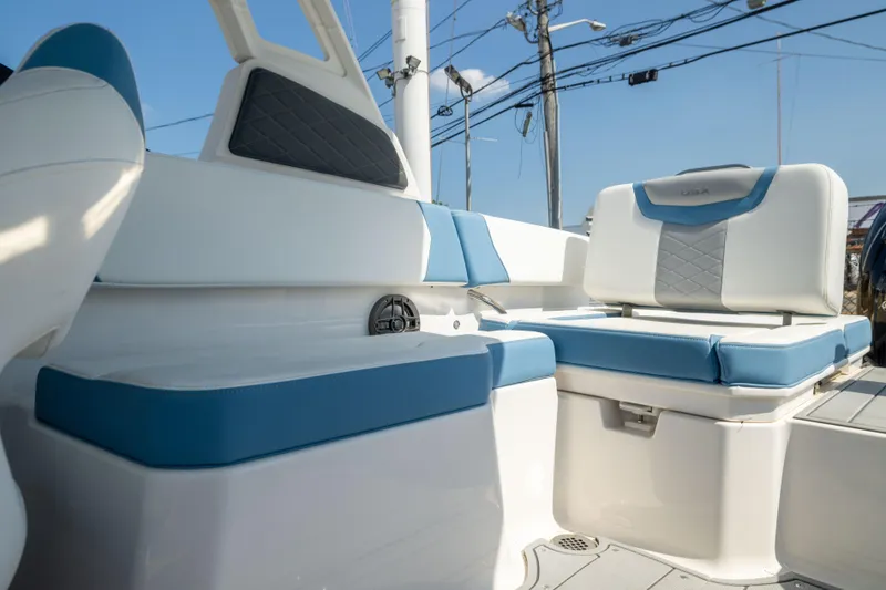 Slide: The Image of 2026 Chaparral 250 OSX boat interior with blue and white seating, showcasing modern design. - 15
