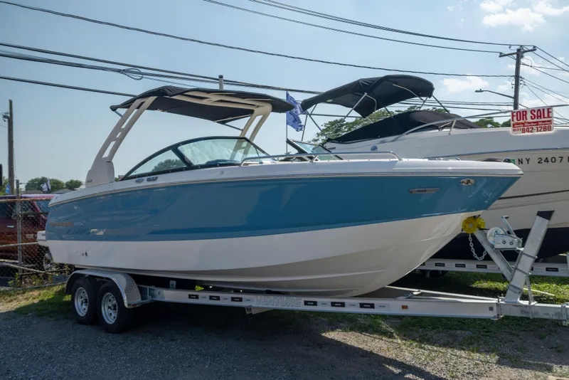 Slide: The Image of 2026 Chaparral 250 OSX boat on trailer, blue and white, for sale. - 3